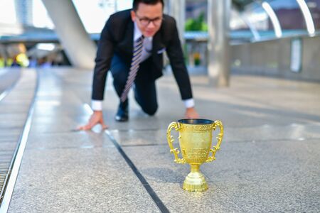 Concept business people, Young business man are competing for wins and trophies.の写真素材