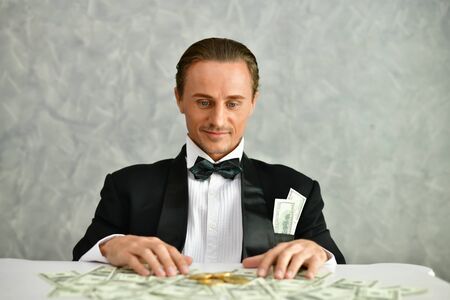 Concept Very wealthy businessman. Businessman is happy with his money.A businessman showing his money.の写真素材