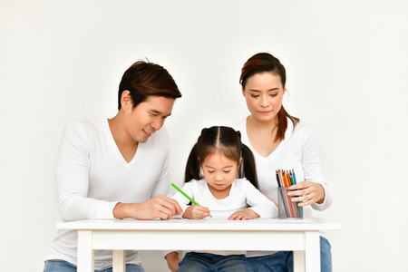 Concept Family. Familys are drawing activities in the home. Family is doing happy activities. Parents are teaching drawing children.の写真素材