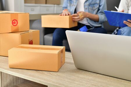 Sme business concept. Young Asian people are packing their packages.Delivery business  Small and...