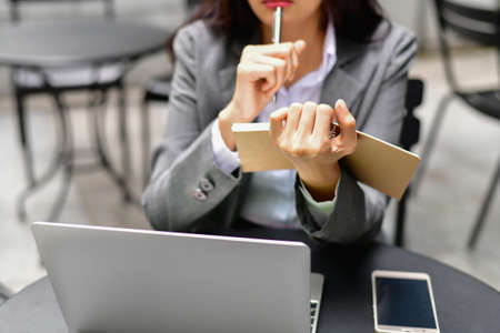 Business Concept.Young Asian businesswoman is working happily.Young businesswoman working in a cafe.Young businesswoman is relaxation in a coffee shop.の写真素材