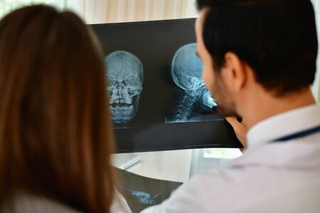 Health Concepts. Doctor and patient viewing x-ray film. The doctor and the patient feel relaxed at the check-in time. The doctor encouraged the patient. Inside the hospital are doctor X-ray patient.の写真素材