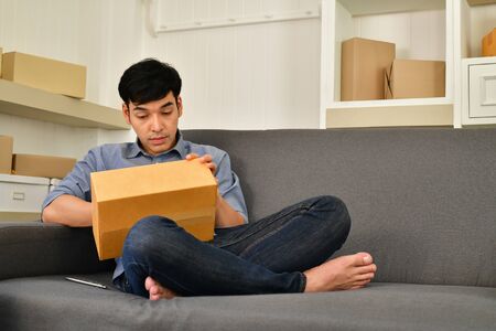 Sme business concept. Young Asian people are packing their packages.Delivery business  Small and...