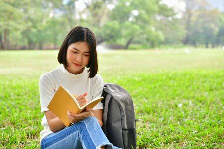 Education Concepts. Asian women reading books in the park. Beautiful women are relaxing in the park. Beautiful women are happy to read. 
Asian girls love to study. Education of Asian Women.の写真素材