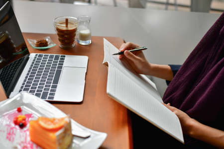 Business Concept.Young Asian businesswoman is working happily.Young businesswoman working in a cafe.Young businesswoman is relaxation in a coffee shop.の写真素材