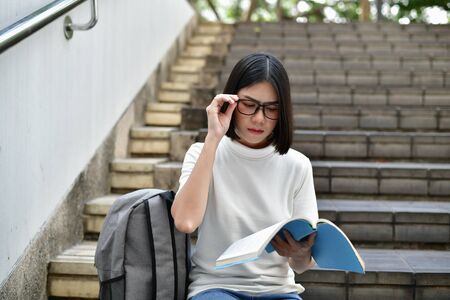 Education Concepts. Asian women reading books in the University. Beautiful women are relaxing in the University. Beautiful women are happy to read. Asian girls love to study. Education of Asian Women.の写真素材