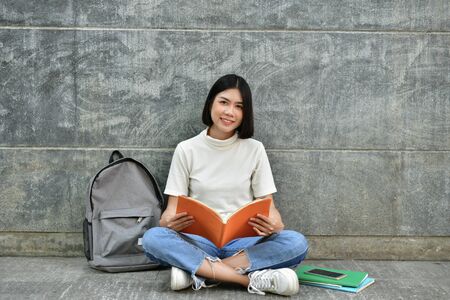 Education Concepts. Asian women reading books in the University. Beautiful women are relaxing in the University. Beautiful women are happy to read. Asian girls love to study. Education of Asian Women.の写真素材