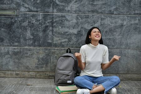 Education Concepts. Asian women reading books in the University. Beautiful women are relaxing in the University. Beautiful women are happy to read. Asian girls love to study. Education of Asian Women.の写真素材