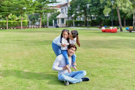 Family Concept. Happy male and female playing with children outside. Family is doing happy activities at Playground.  Parents are playing happily.の写真素材