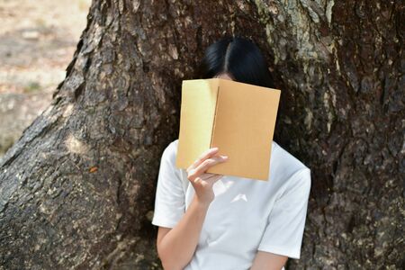 Education Concepts. Asian women reading books in the park. Beautiful women are relaxing in the park. Beautiful women are happy to read. 
Asian girls love to study. Education of Asian Women.の写真素材