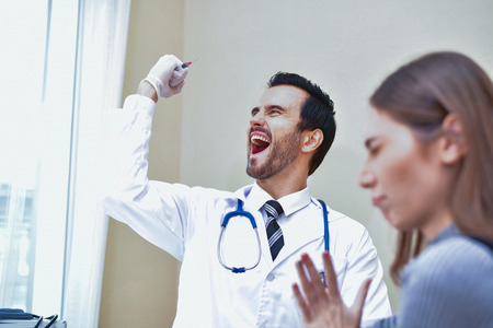 Terrible medical concept. Patients are afraid to go to the doctor. Patients afraid of injection. Patients do not like syringes. Patients fear and anxiety.の写真素材