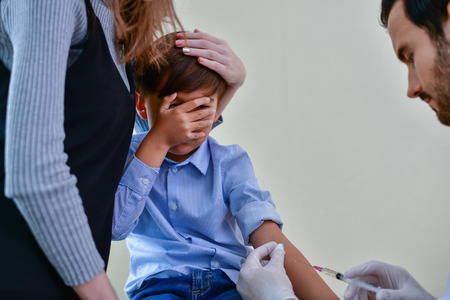 Terrible medical concept. Patients are afraid to go to the doctor. Patients afraid of injection. Patients do not like syringes. Patients fear and anxiety.の写真素材