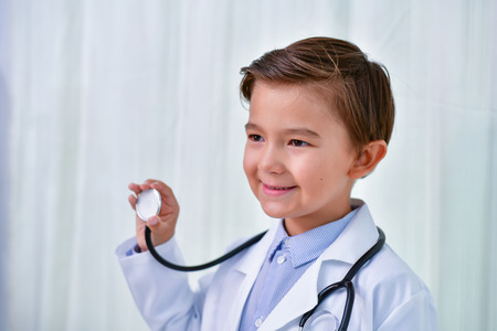 Young doctor Concept, The Young doctor is smiling on a white background. Young man wants to be a good doctor. The young man will grow up to be a doctor.の写真素材