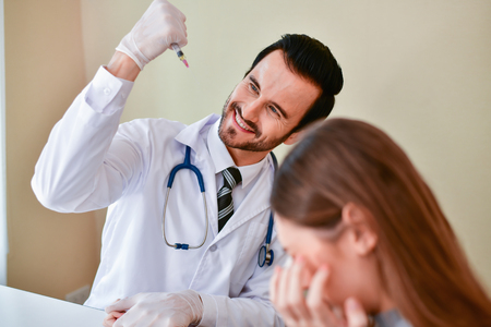 Terrible medical concept. Patients are afraid to go to the doctor. Patients afraid of injection. Patients do not like syringes. Patients fear and anxiety.の写真素材