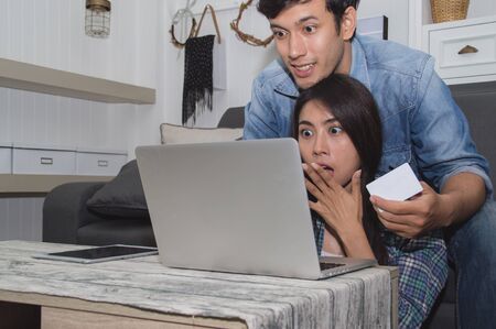 Couples Concept. Lovers are playing in the living room. Couples are shopping through the Internet....