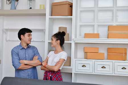 Sme business concept. Young Asian people are packing their packages.Delivery business  Small and Medium Enterprise (SMEs). Young man is working in the house.Young Owner Start up for Business Online.の写真素材