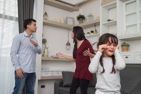 The concept of parental family quarrels, Young Couple Parents are fighting in front of children. The children are very sad to the parents quarrel. Children are crying and headaches.の写真素材