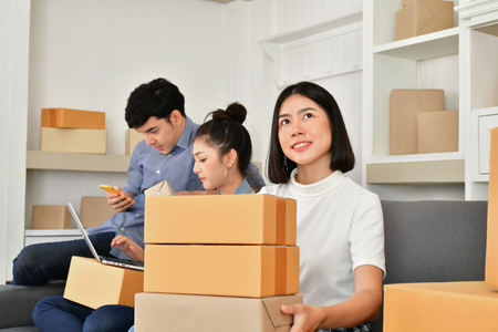 Sme business concept. Young Asian people are packing their packages.Delivery business  Small and Medium Enterprise (SMEs). Young man is working in the house.Young Owner Start up for Business Online.の写真素材