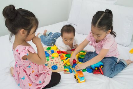 Childrens are learning skills to play with toys. Concepts of learning skills.