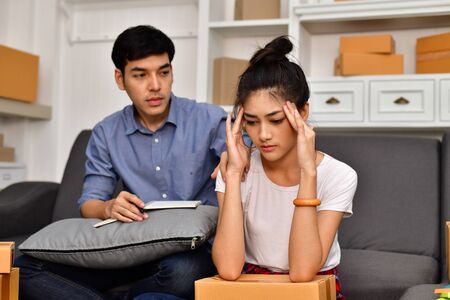 Sme business concept. Young Asian people are packing their packages.Delivery business  Small and Medium Enterprise (SMEs). Young Owner are stressed with delivery and Start up for Business Online.の写真素材