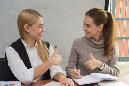 Business Concepts, Young business woman is meeting in office. Young businesswoman is working happily. Businesswomen work as a team for success. Business people work with smiles.の写真素材
