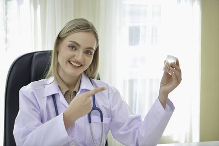 Doctor Concept. Smiling doctor posing in the office. Young doctor is wearing a stethoscope. medical...