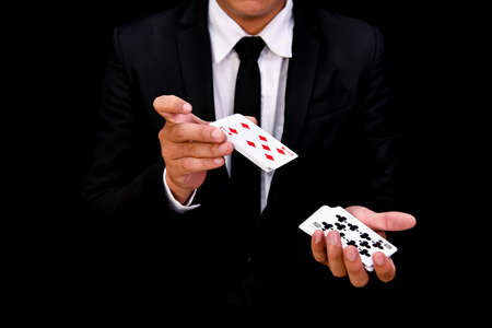 Gambling Concepts. Businessmen are gambling in the casino. Betting is a gamble for investors. Businessmen are playing card games on a black background.の写真素材