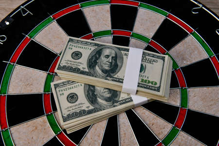 Finance Business Concepts. Businessman is playing darts. Businessmen are aiming for work. Businessman looking at a lot of money.の写真素材
