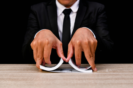 Gambling Concepts. Businessmen are gambling in the casino. Betting is a gamble for investors. Businessmen are playing card games on a black background.の写真素材