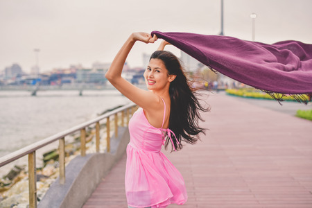 Travel Concepts. Beautiful girl relaxing on the beach. Beautiful girl is happy to come to the beach. Beautiful girl is walking the beach. Happy women and relaxing on the seashore.の写真素材