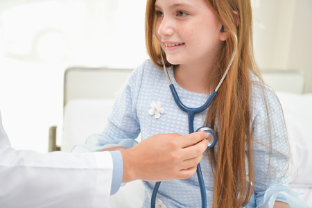 Health Concepts. The doctor is examining the health of the child. The doctor is talking to the patient. Children are happy in the hospital.の写真素材