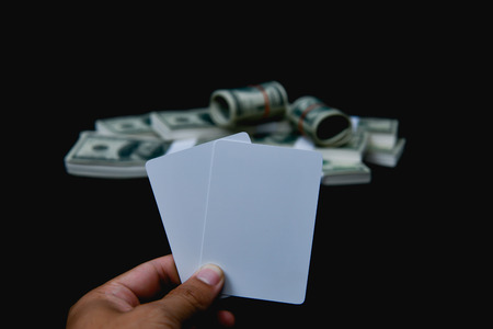 Gambling Concepts. Businessmen are gambling in the casino. Betting is a gamble for investors. Businessmen are playing card games on a black background.の写真素材