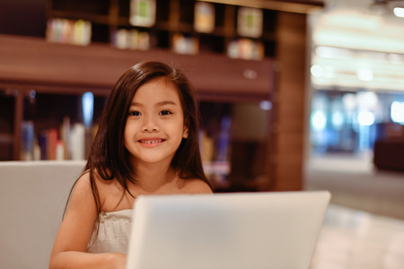 Education Concepts. The girl is studying in the library. Beautiful girls are happy learning.の写真素材