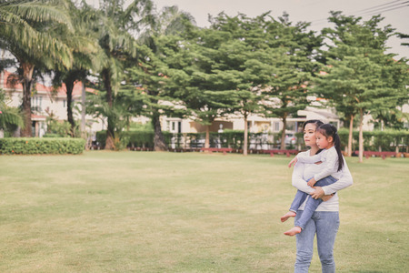 Family Concept. Happy male and female playing with children outside. Family is doing happy activities at Playground.  Parents are playing happily.の写真素材
