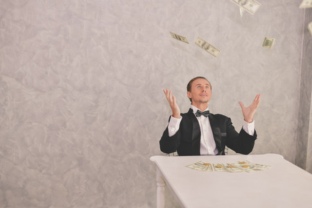 Concept Very wealthy businessman. Businessman is happy with his money.A businessman showing his money.の写真素材