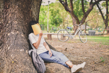 Education Concepts. Asian women reading books in the park. Beautiful women are relaxing in the park. Beautiful women are happy to read. 
Asian girls love to study. Education of Asian Women.の写真素材