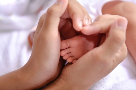 Newborn Concept. Newborn babies are sleeping in a bed. The baby is in the white bedroom.の写真素材