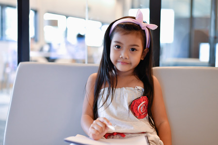 Education Concepts. The girl is studying in the library. Beautiful girls are happy learning.の写真素材