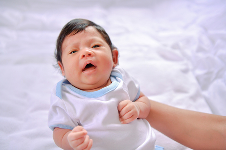 Newborn Concept. Newborn babies are sleeping in a bed. The baby is in the white bedroom.の写真素材