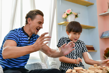Family Concept. Family is happy in the house. Dad and son are playing fun at home.の写真素材