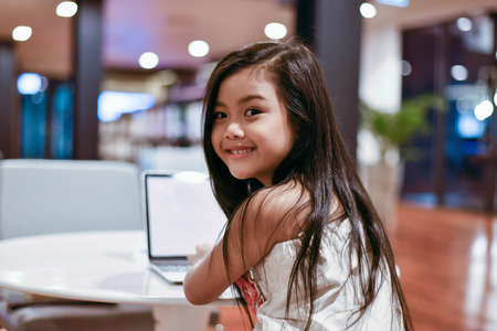 Education Concepts. The girl is studying in the library. Beautiful girls are happy learning.の写真素材