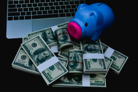 Finance Business Concepts. Lots of money on a black background. Investments are a necessity of business. Businessman looking at a lot of money.の写真素材