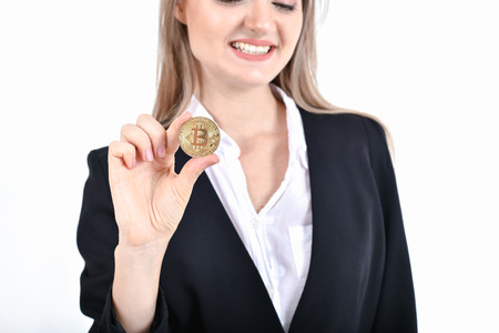 bit-coin business concept. Beautiful businesswoman is counting her money. Young business are enjoying the money and earning. Young business are happy and is saving money with the bitcoinの写真素材