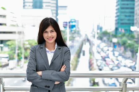 Business Concept. Young businessmen are expressing emotions in the city. Asian businesswoman standing in business district. Asian business woman is happy in the city.の写真素材