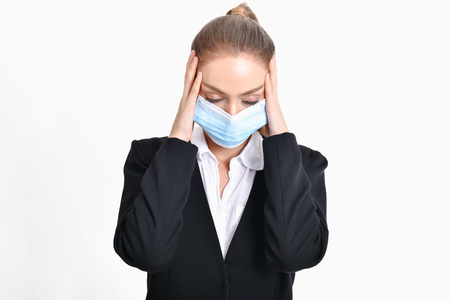 Business concept. Young businesswoman is very sick. 
Young businesswoman is on a white background.の写真素材