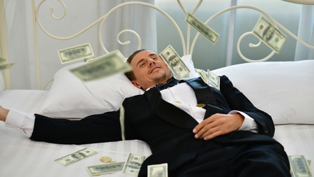 Concept Very wealthy businessman. Businessman is happy with his money.A businessman showing his money.の写真素材