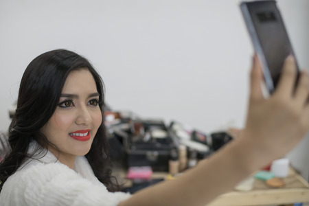 Beautiful sexy girl is playing her mobile.の写真素材