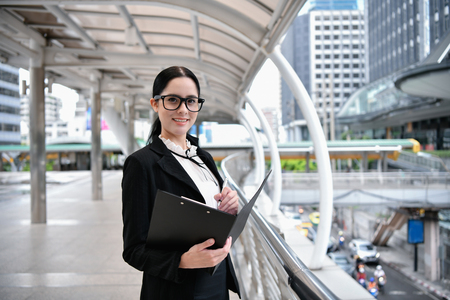 Business concept. Young businesswoman is working in business district. Young businesswoman happy to work.の写真素材