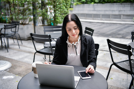 Business concept. Young businesswomen in the coffee shop. Young business people are working happily.の写真素材