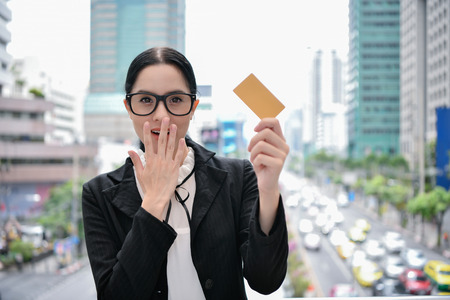 Business concept. Young business people are spending money with credit cards. Beautiful girl is happy with her credit card.の写真素材